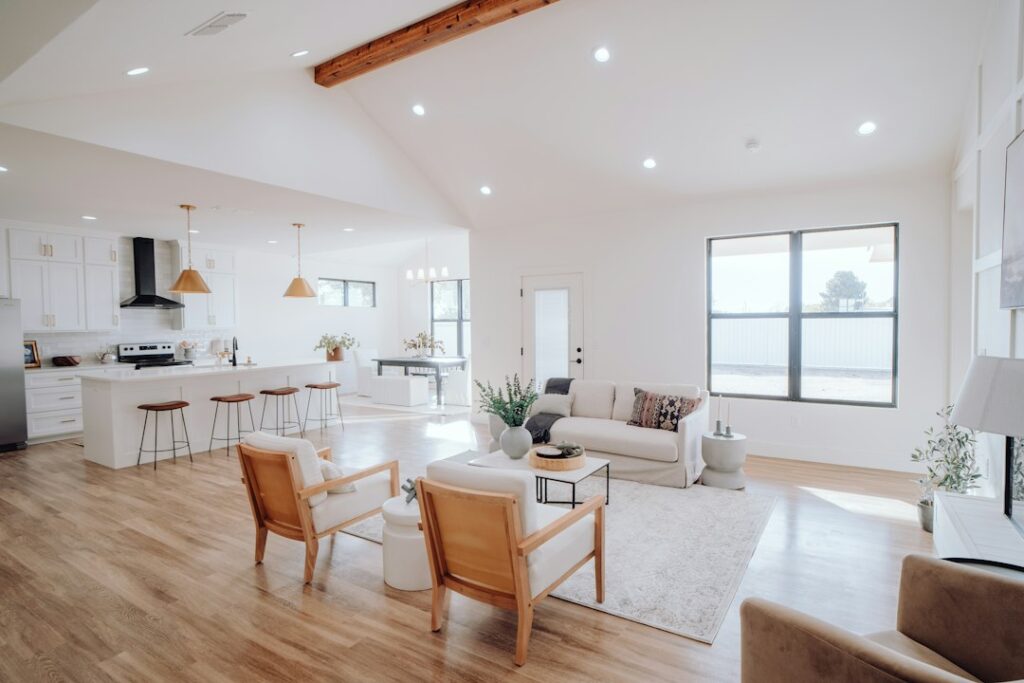a living room filled with furniture and a kitchen