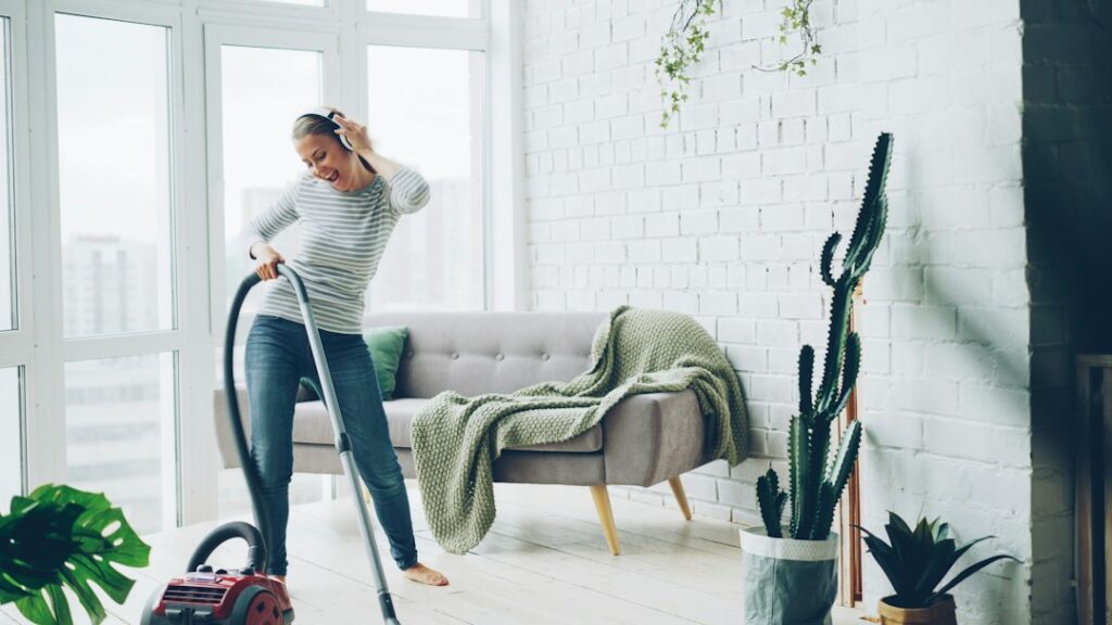 Woman happily vacuuming a bright, modern living room