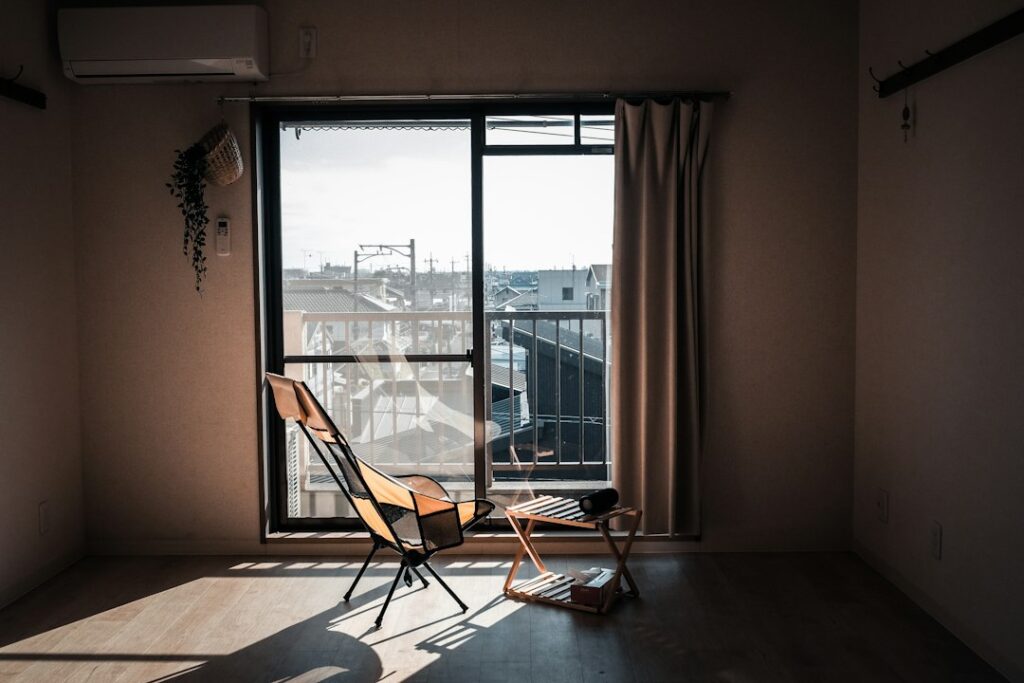 Sunlight streams into a simple room with chairs